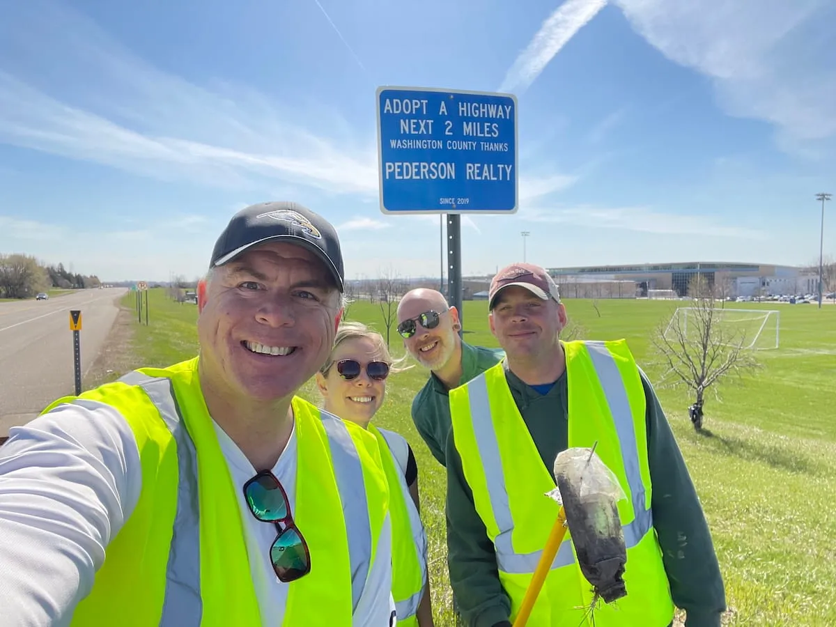 Pederson Realty team members volunteering together during an Adopt a Highway roadside cleanup event